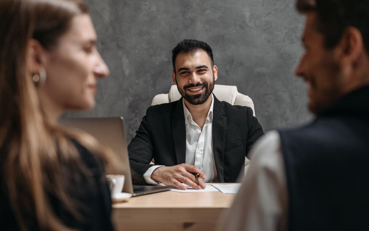 Business professional speaking with customers during an office consultation