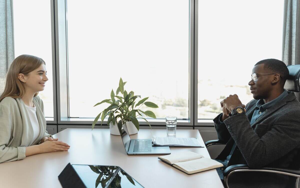 Interviewer and candidate speaking during an office interview