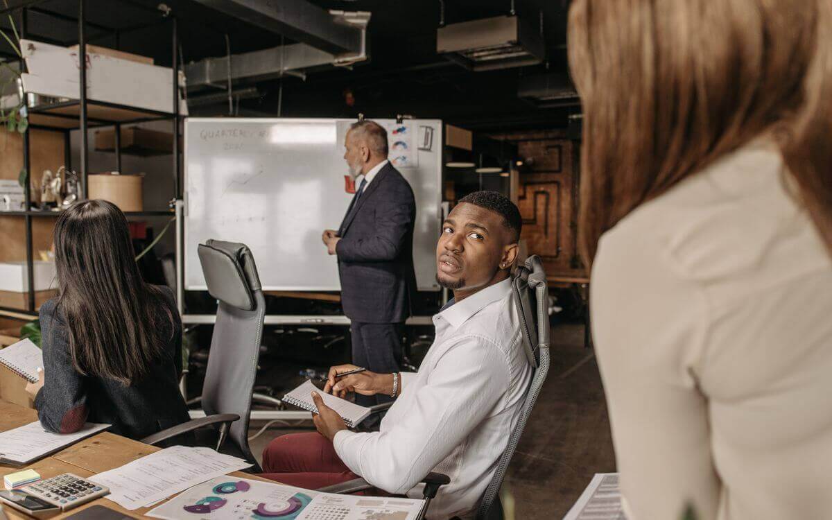 Multilingual team members discussing ideas during an office meeting