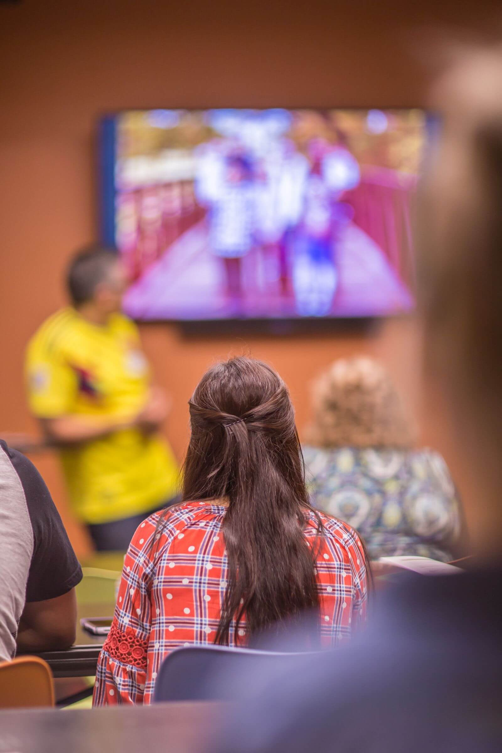 Students watching a classroom presentation on a projected screen.