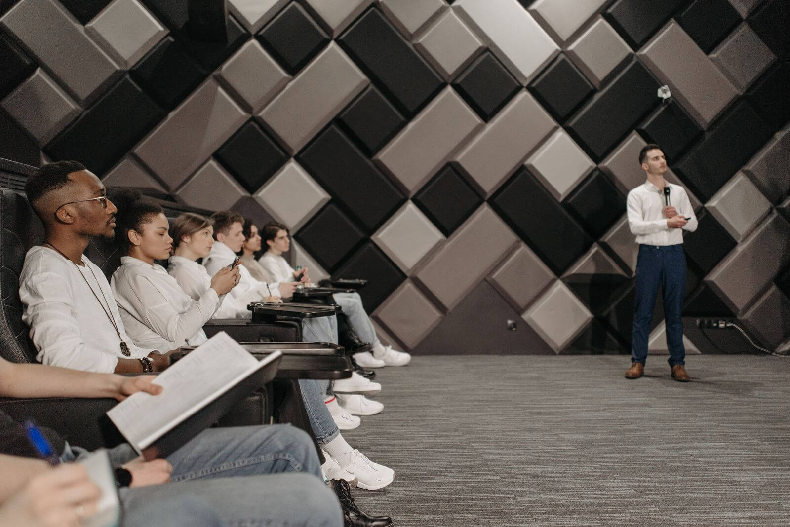 A keynote speaker presenting to a seated conference audience.